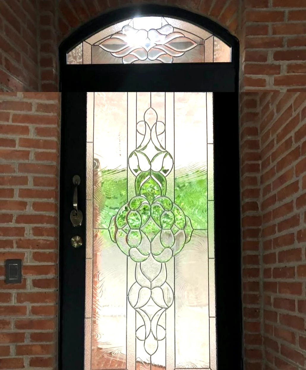 Puerta oscura con vitral ornamental verde y cristal texturizado